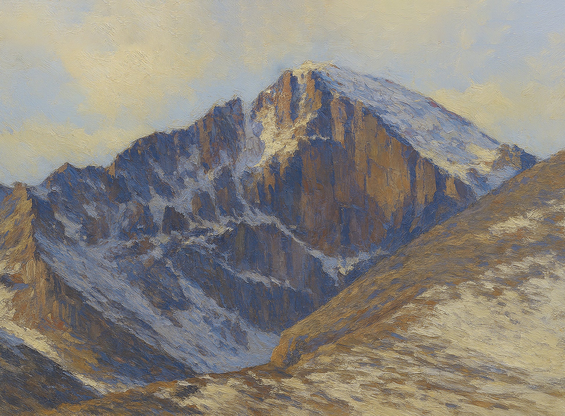 Snow-streaked east face of Longs Peak rising under a grey overcast sky with deep blue shadows across the rock.