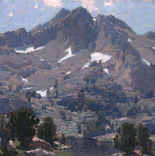 Oil painting of Sierra Landscape by Edgar Payne, featuring a broad granite Sierra peak in grey-blue dominating the canvas above an alpine lake and pine-clad slopes under a light scattered sky.